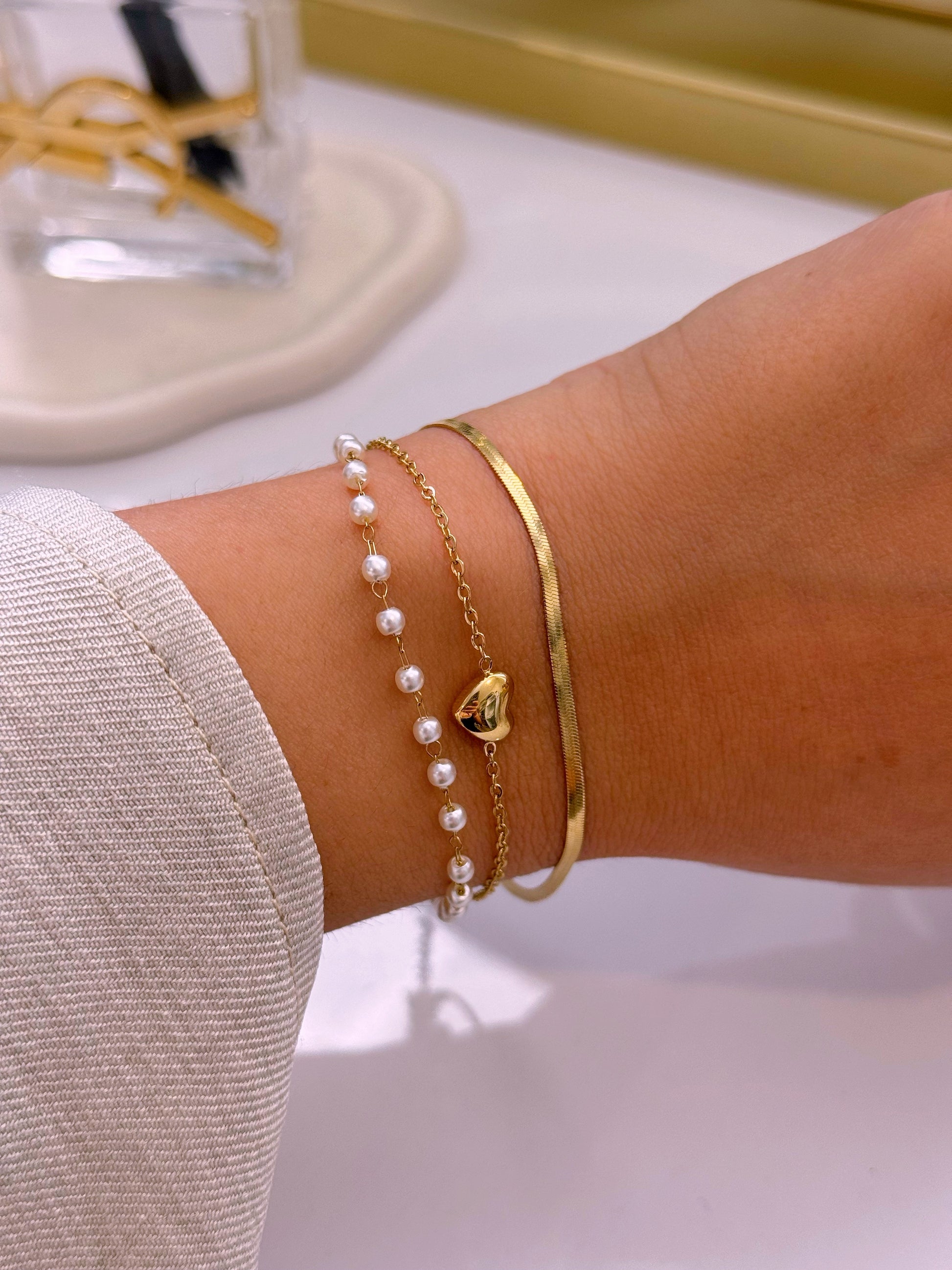 Pulseira efeito triplo • malha achatada, fininha com pérolas e fininha com coração | Dourado